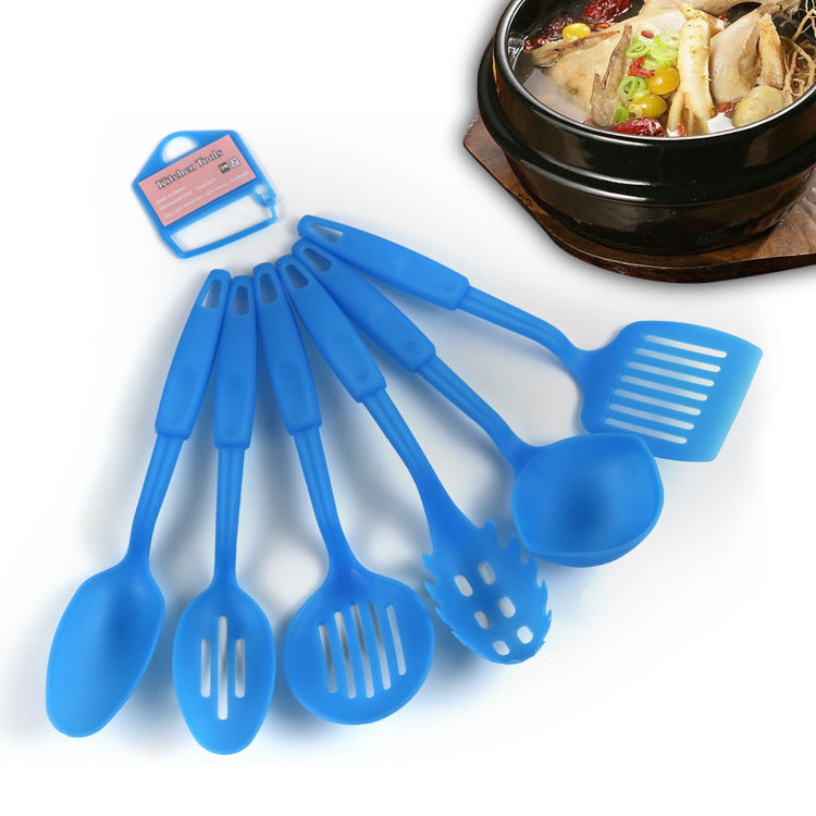 Set of blue silicone kitchen utensils with a pot of food in the background