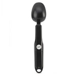 Black measuring spoon on a white background