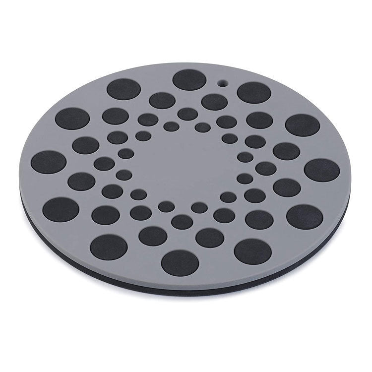 Round gray mat with black circular patterns on a white background