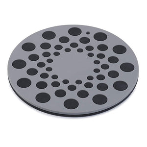 Round gray mat with black circular patterns on a white background