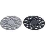 Two round silicone trivets, one gray and one black, on a white background.