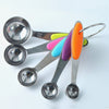 Set of metal measuring spoons with colorful silicone handles on a white background