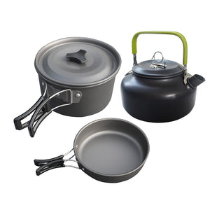 Set of camping cookware including a pot, pan, and kettle on a white background