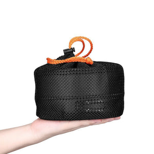 Black mesh bag with orange handle held in a hand on a white background