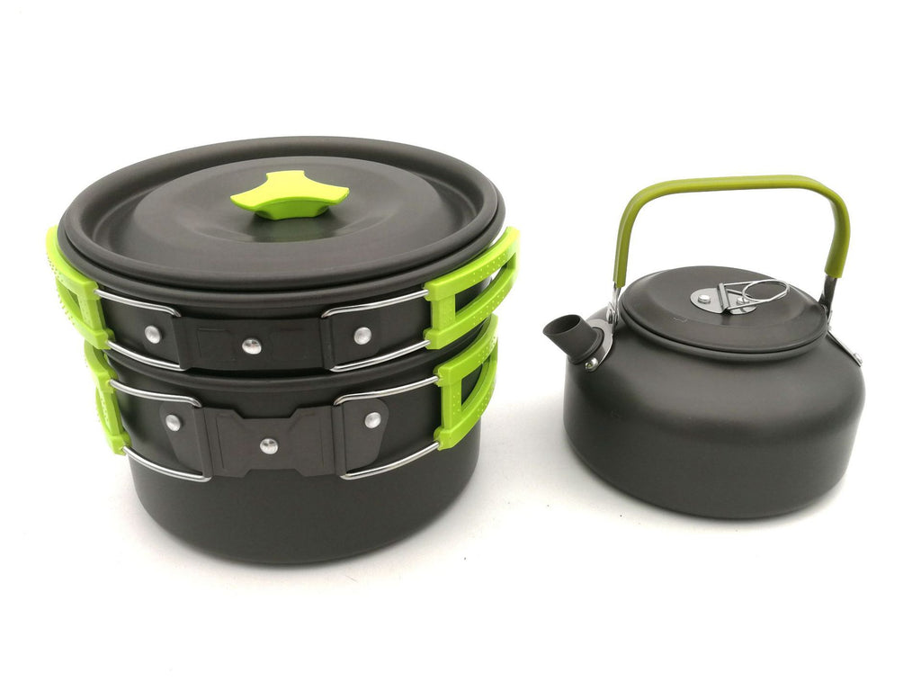 Black and green camping cookware set on a white background