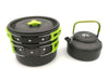 Black and green camping cookware set on a white background